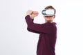 Young man using a VR headset and playing in virtual reality isolated on white background. Copy space and mock up Royalty Free Stock Photo