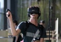 Young man using VR set at sonar festival with hand handles