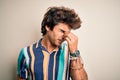 Young man on vacation wearing summer colorful shirt standing over  white background tired rubbing nose and eyes feeling Royalty Free Stock Photo