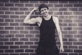 Young man in vest top flexing biceps Royalty Free Stock Photo