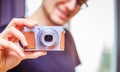 Young man takes a picture with a retro camera Royalty Free Stock Photo