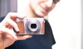 Young man takes a picture with a retro camera Royalty Free Stock Photo