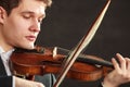 Young man violinist shocked, broken bow