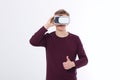 Young man in virtual reality glasses isolated on white background and big thumb up. Vr concept. Template and blank shirt. Royalty Free Stock Photo