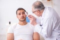 Young man visiting experienced doctor dermatologist