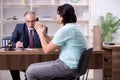Young man visiting experienced male lawyer Royalty Free Stock Photo