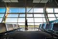 Young man waiting for departure at the airport while using his phone Royalty Free Stock Photo