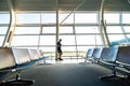 Young man waiting for departure at the airport while using his phone Royalty Free Stock Photo