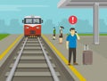 Young man waiting his train and calling the phone on platform while train is approaching. Railroad safety rules and tips.
