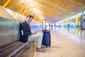 Young man waiting listening music and using mobile phone at the Royalty Free Stock Photo