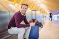 Young man waiting listening music and using mobile phone at the Royalty Free Stock Photo