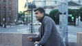 Young man is waiting for meeting on street in center of city. Media. Attractive man is waiting for girlfriend at Royalty Free Stock Photo