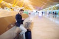 Young man waiting and using mobile phone at the airport Royalty Free Stock Photo