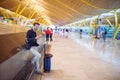 Young man waiting and using mobile phone at the airport Royalty Free Stock Photo