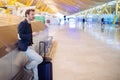 Young man waiting and using mobile phone at the airport Royalty Free Stock Photo