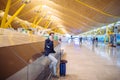 Young man waiting and using mobile phone at the airport Royalty Free Stock Photo