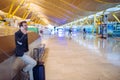 Young man waiting and using mobile phone at the airport Royalty Free Stock Photo