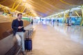 Young man waiting and using mobile phone at the airport Royalty Free Stock Photo