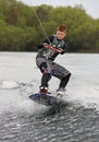 A young man wake-boarding / surfing