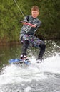 A young man wake-boarding / surfing Royalty Free Stock Photo