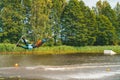 Young man wakeboarding down the lake making different tricks and jumps Royalty Free Stock Photo