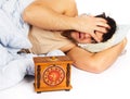 Young man wakes to a loud alarm clock Royalty Free Stock Photo