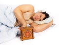 Young man wakes to a loud alarm clock Royalty Free Stock Photo