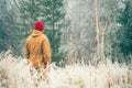 Young Man walking alone outdoor with foggy scandinavian forest nature on background