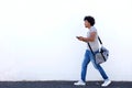 Young man walking with bag and cell phone Royalty Free Stock Photo