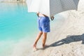 A young man is walking barefoot on the beach. Royalty Free Stock Photo