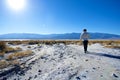 Young Man Walking Through Barren Land