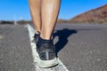 Young man walking by the center line of a road Royalty Free Stock Photo