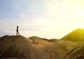 Young man walking  desert sunrise on mountain Royalty Free Stock Photo