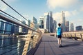 Young man walking exercise along bridge near Marina bay in Singapore