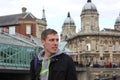 Young man is walking in historic centre of English town