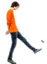 Young man walking kicking tin can side view Royalty Free Stock Photo