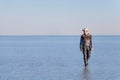 Young man walking and looking away with perfect blue sky reflection in Salar de Uyuni - Uyuni Salt Flats in Bolivia Royalty Free Stock Photo