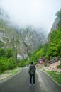 Young man walking on a mountains road Royalty Free Stock Photo