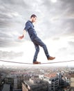Young man walking on a rope in balance Royalty Free Stock Photo