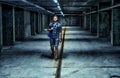 Young man walking through a shadowy basement