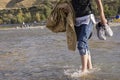 A Young Man Walking in Shallow Water by Bare Foots