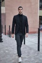 Confident young man walking on a European city street Royalty Free Stock Photo