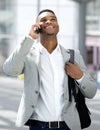 Young man walking and talking on mobile phone Royalty Free Stock Photo