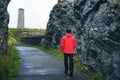 Young man walking towards Wicklow Head Lighthouse in Ireland Royalty Free Stock Photo