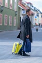 Young man walking through town with a suitcase Royalty Free Stock Photo