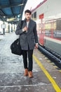 Young man walking at train station Royalty Free Stock Photo