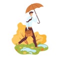 Young man walking with umbrella avoiding puddles, autumn day scenario. Businessman with briefcase on rainy fall day