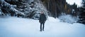 Young man is walking in winter mountains Royalty Free Stock Photo