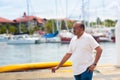 Young man walking in yacht club resort Royalty Free Stock Photo