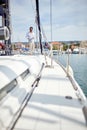A young man walking on a yacht while riding through a town`s dock on the seaside. Summer, sea, vacation Royalty Free Stock Photo